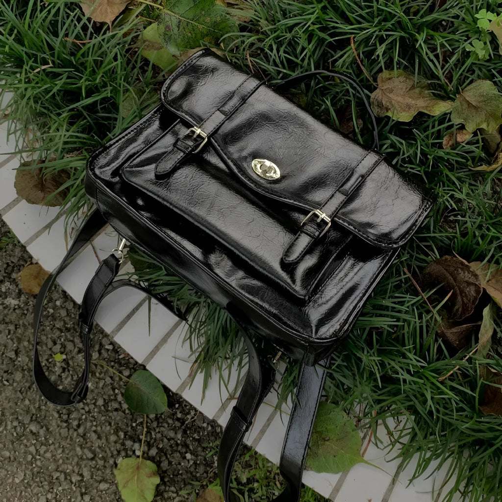 Black oil wax PU leather messenger bag with adjustable shoulder strap showing 35cm length