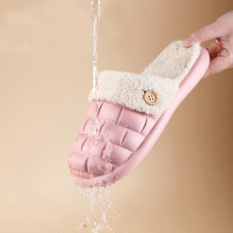 Women's pink and grey plaid EVA slippers with a detachable upper and plush lining on a wooden floor.