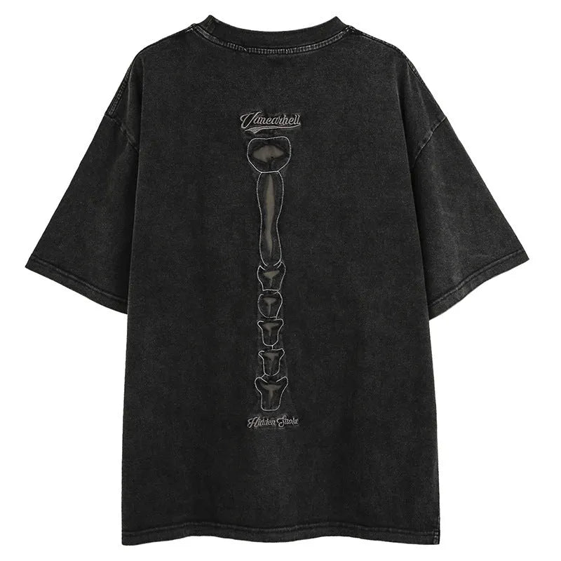 Man modelling a loose black cotton pullover with a white skull and letter graphic print on the front.