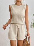 Apricot or orange sleeveless round neck vest and matching shorts set laid flat