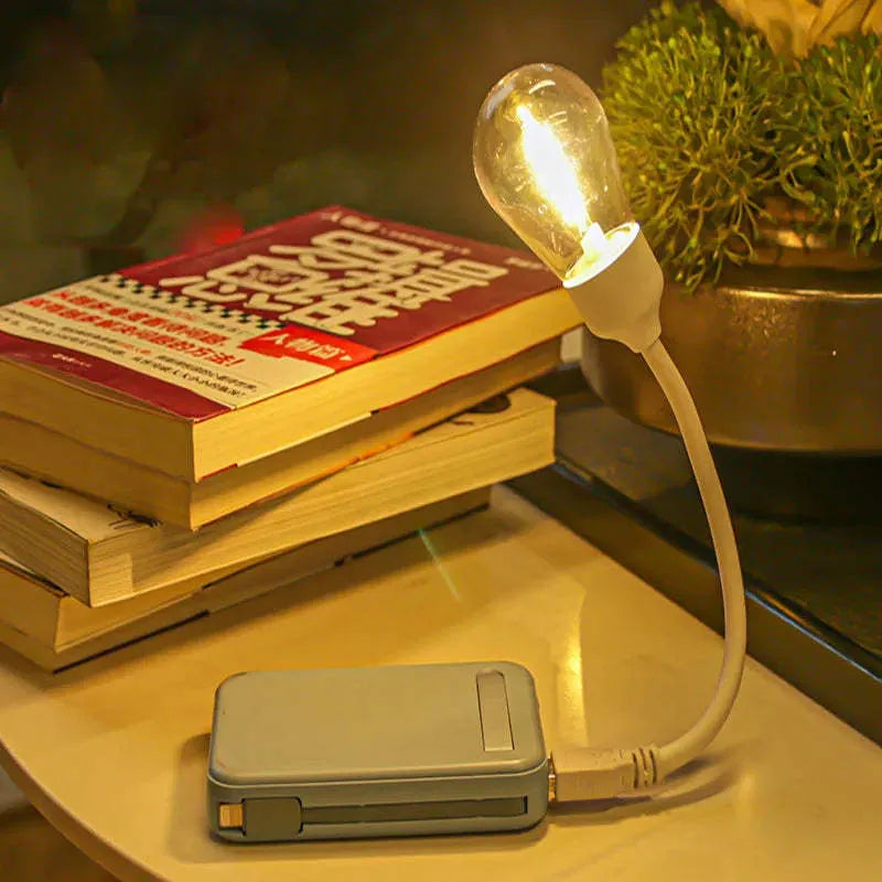 USB rechargeable folding night light with warm white tungsten bulb, shown in open and closed positions.