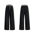 Drooping straight-leg high-waisted casual trousers with button detail in black and grey.