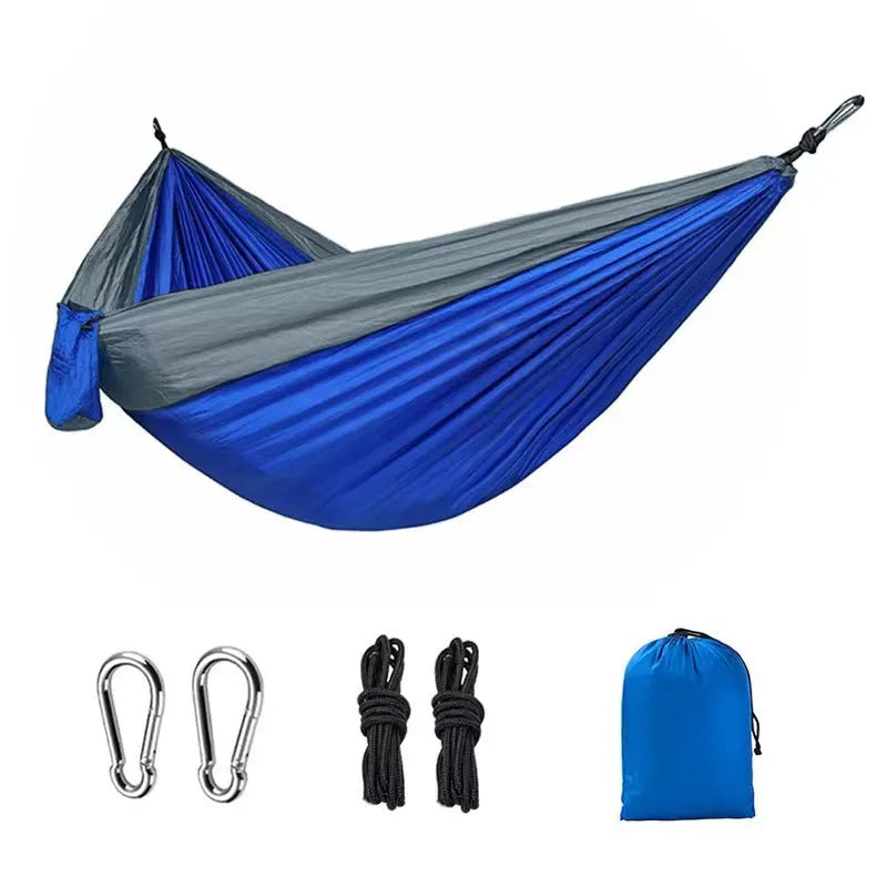 Blue nylon outdoor camping hammock with 300kg load capacity shown suspended between trees