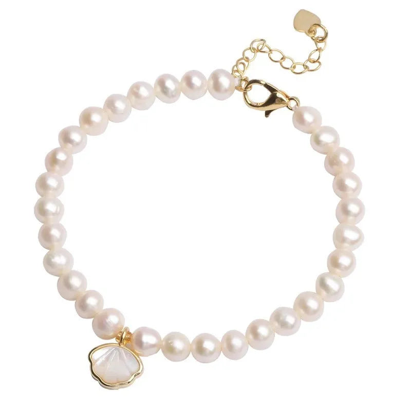 Women's freshwater pearl bracelet with fan-shaped design and alloy shell clasp, showing elastic string and extension chain options.