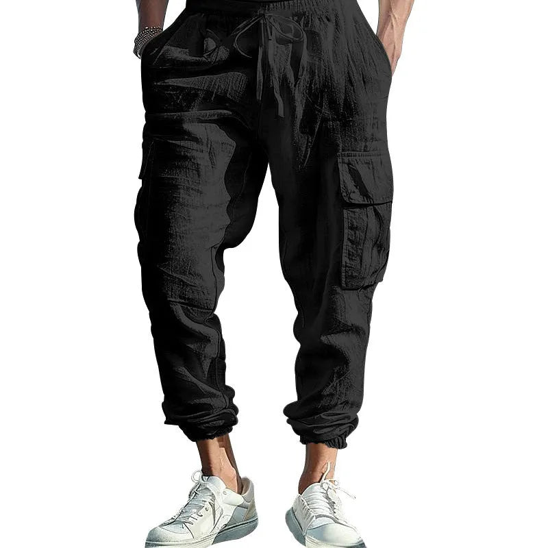 Men's ankle-tied loose fit linen casual trousers in army green, showing multiple pockets and drawstring waist.