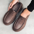 Men's slip-on work shoes in black with waterproof platform sole and mid heel, side view