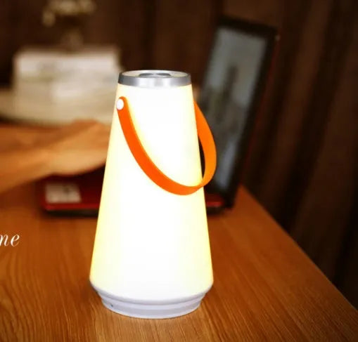 White LED rechargeable night light on a bedside table, 12x12x22cm ABS plastic body with warm glow