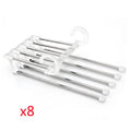 Black 5-in-1 stainless steel trouser hanger with five booms and dual hooks on a clothes rack