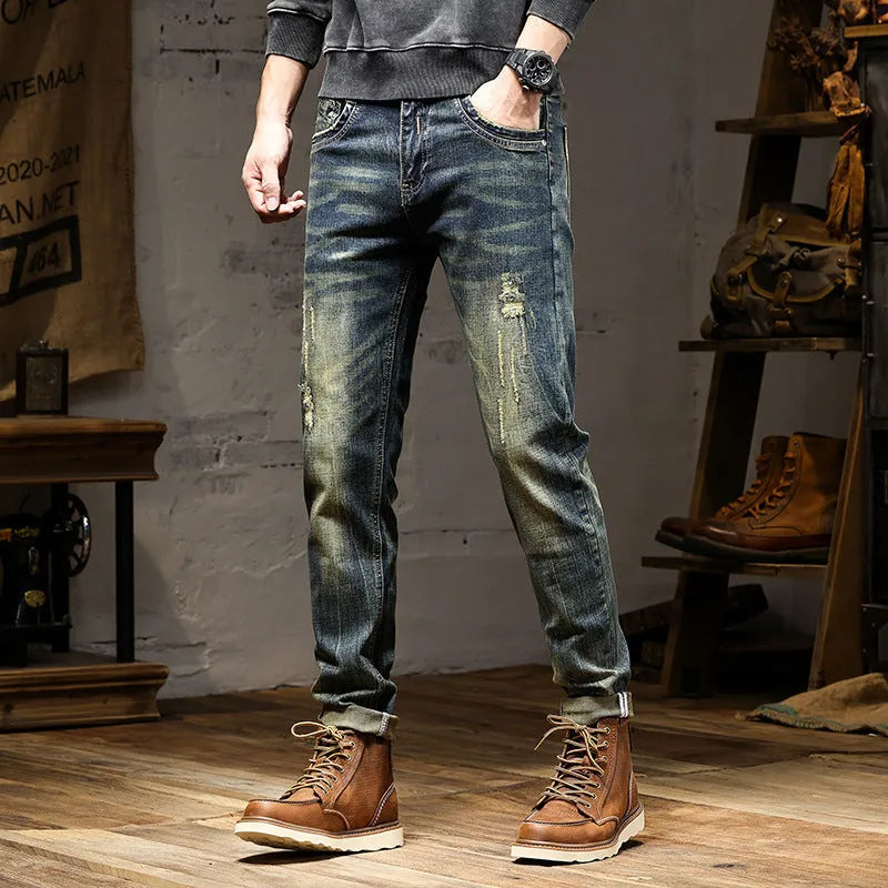 Men's skinny fit jeans in a retro blue denim wash with a zip fly closure.