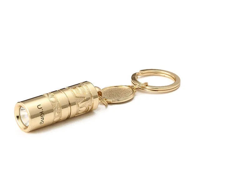 Gold-coloured zinc alloy waterproof mini LED keychain flashlight on a keyring.