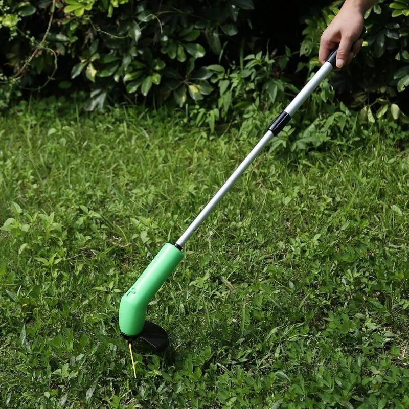 Cordless lawn trimmer weed trimmer with extension pole and debris shield on green grass