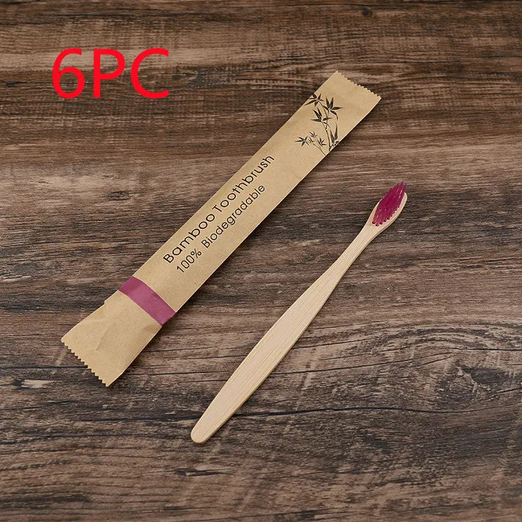 10 bamboo toothbrushes with soft charcoal bristles in assorted colours arranged fanned out