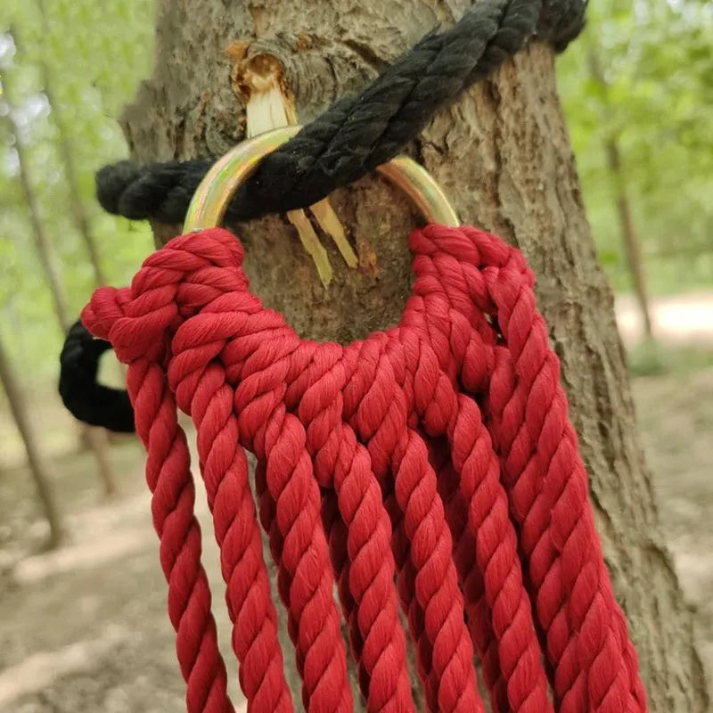Nylon rope mesh hammock hanging between trees with bold weave pattern, showing 1.1m width