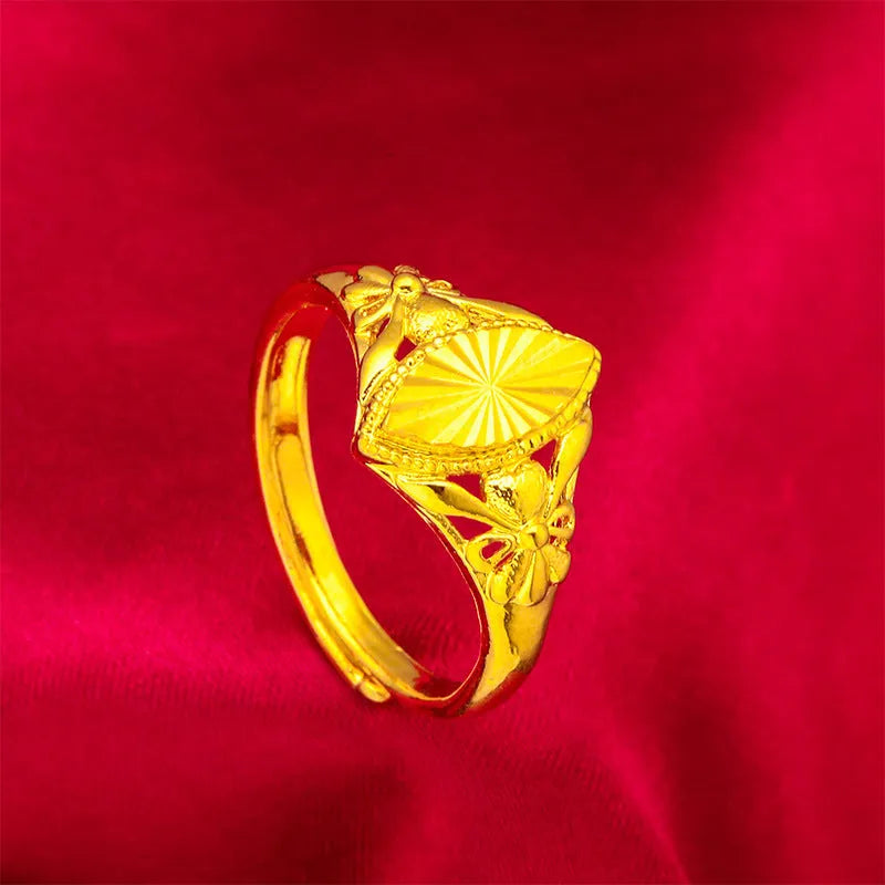 Gold coloured open diamond flower shape ring with geometric textured details on a brass base.