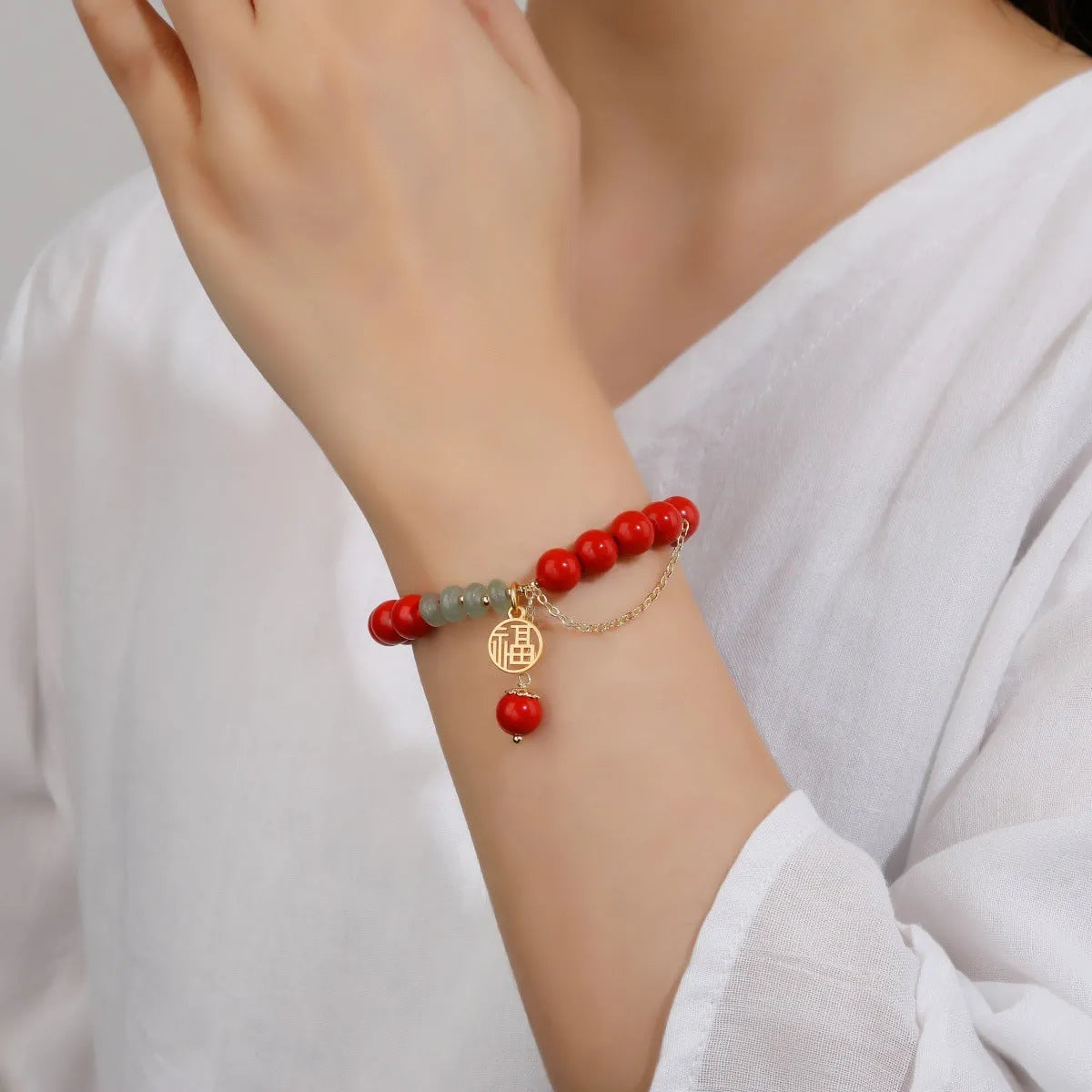 Retro women's red sand cinnabar bracelet with jade spacers and Fu character tassel, 8mm beads