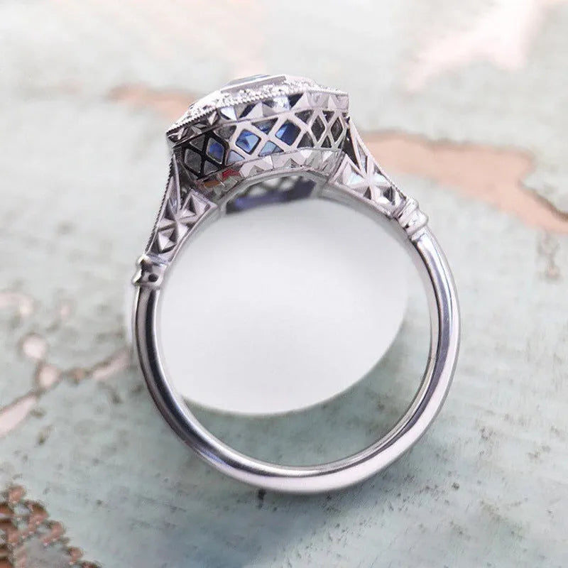 Blue long hexagon copper electroplated women's ring on plain background, sizes 6 to 10