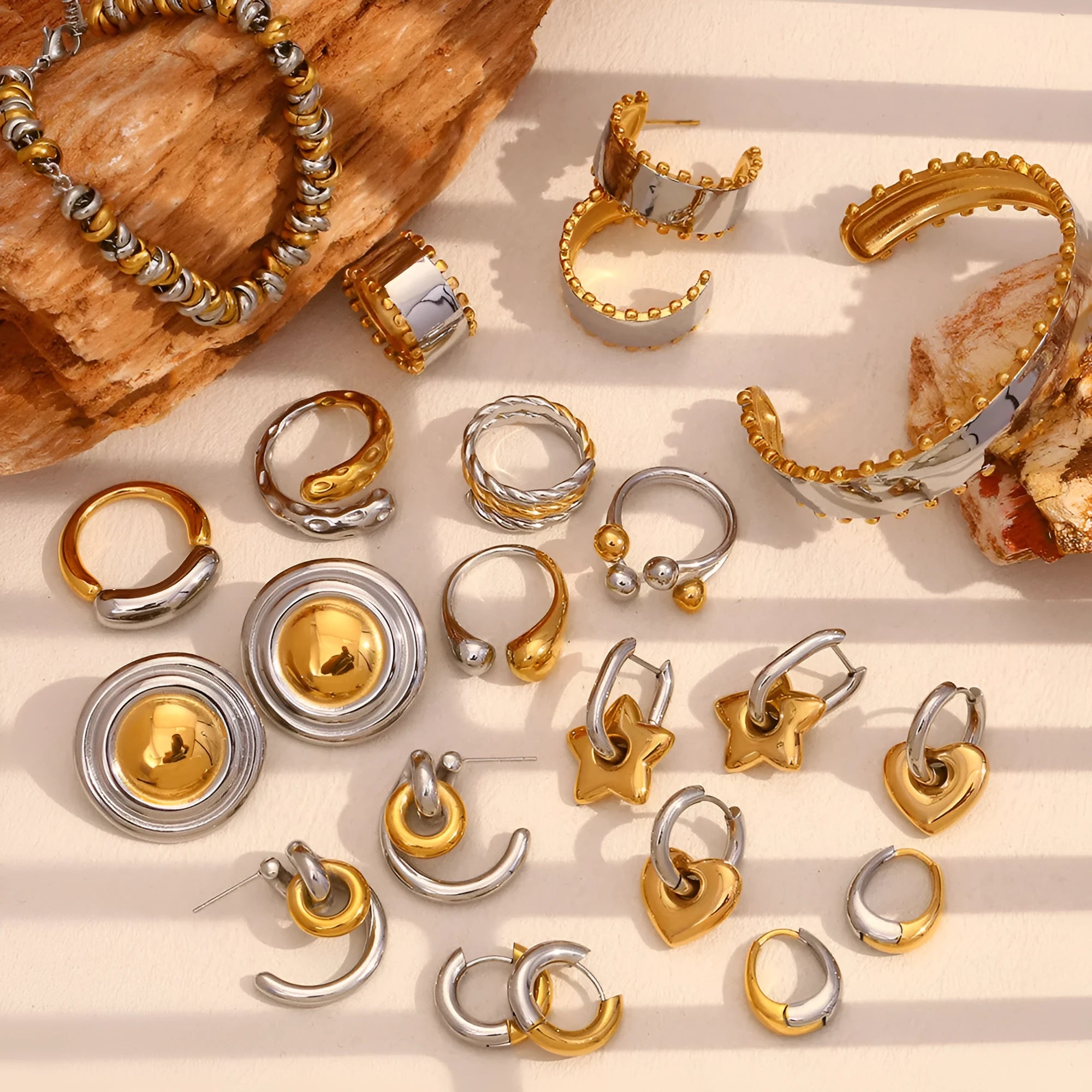 Gold electroplated women's jewellery set showing geometric earrings, bracelet, and necklace on a flat lay.