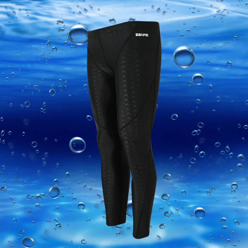 Men's nylon swimming trunks in black with grey trim, showing cropped brief style with mesh lining
