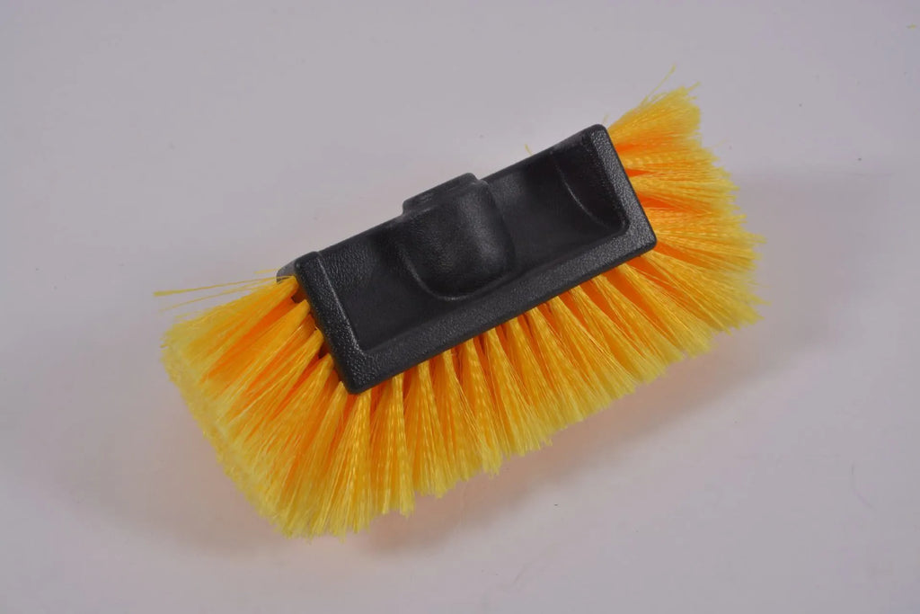 Yellow portable car wash brush with four-section rod on a clean car surface, showing flow-through design