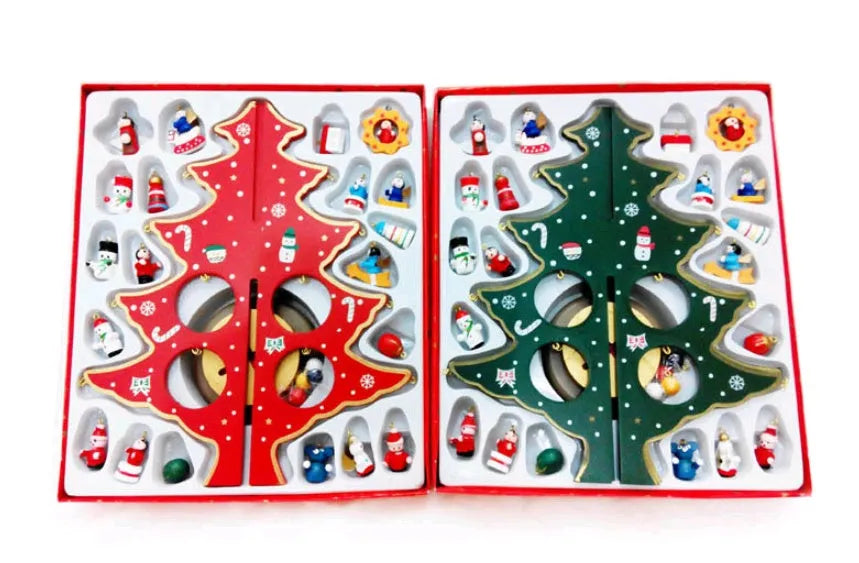 Set of three hand painted wooden Christmas trees in green on a table, largest 36cm tall