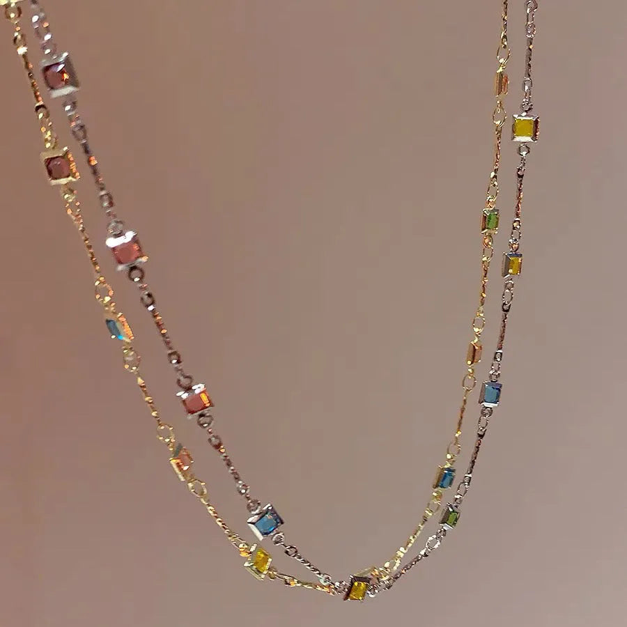 Square colour geometric quadrilateral alloy clavicle chain necklace with artificial crystal details on a model.