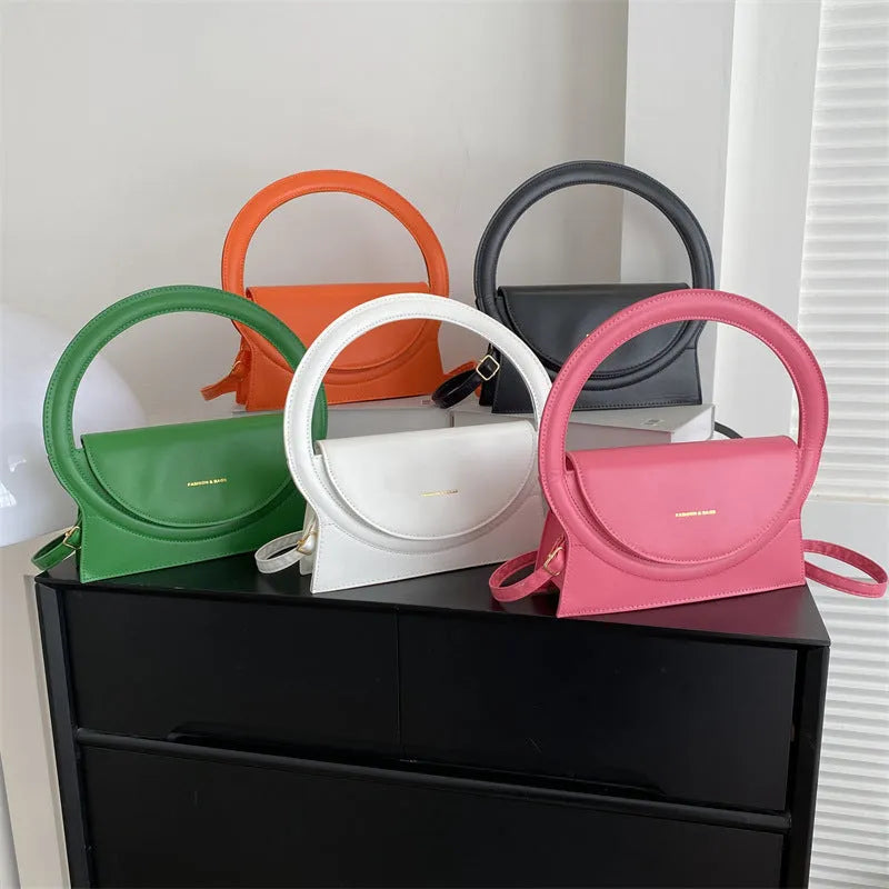 PU leather messenger bag in horizontal square shape with phone pocket and stitching details