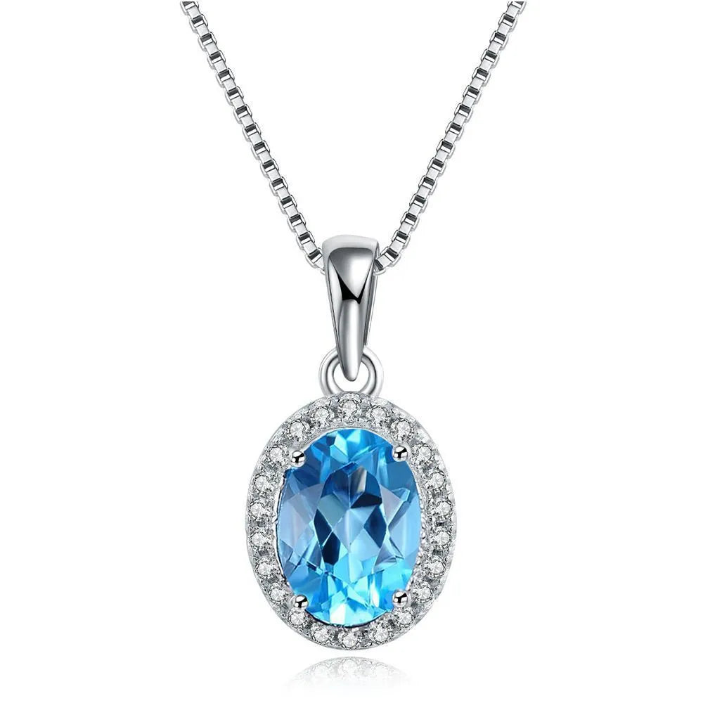 925 sterling silver jewellery set with blue topaz gems showing earrings, ring, pendant, and necklace with geometric design