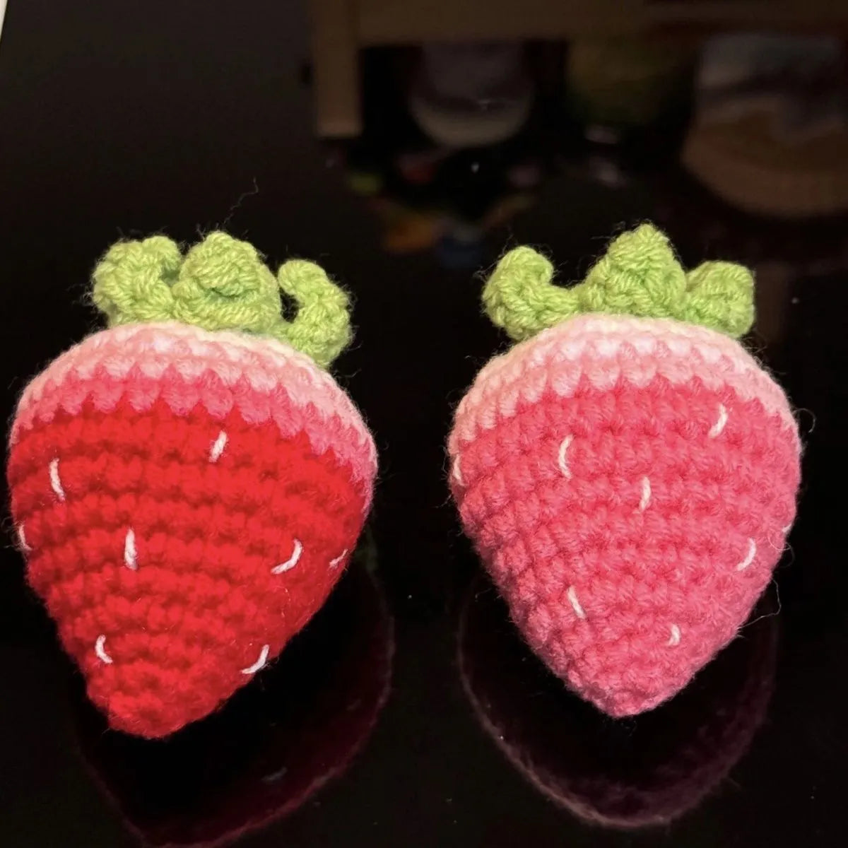 Plush strawberry pendant keychain in pink with metal ring on a white background