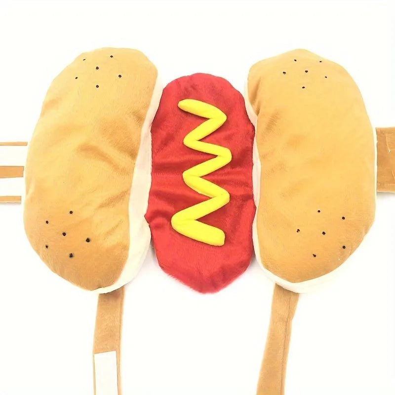 A small dog wearing a brown and beige plush hot dog costume with openings for head, legs, and tail.