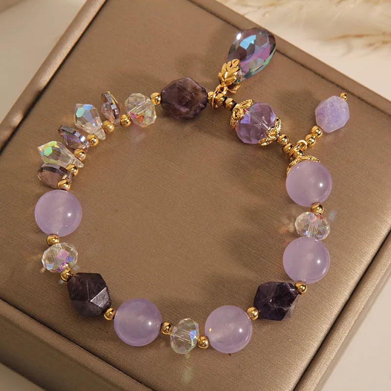 Children's crystal bracelet with lavender purple water-drop crystals on a plain background
