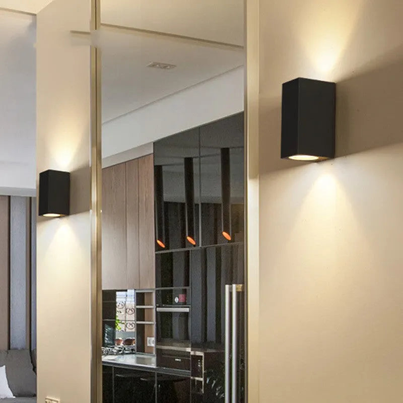 Modern aluminium and glass LED wall lamp in a black finish with silicone rubber trim.
