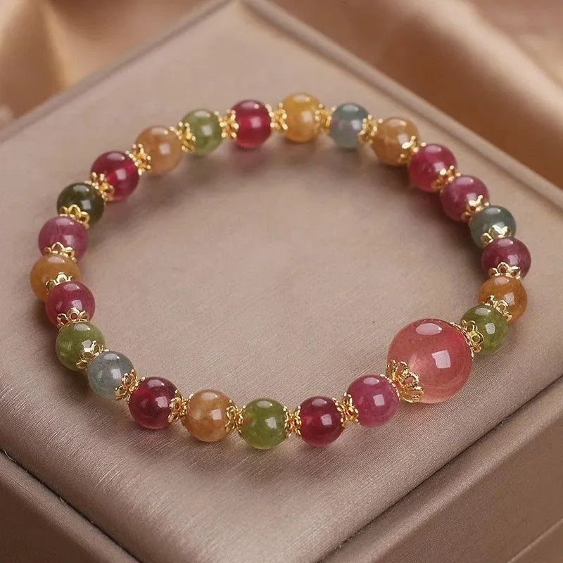Natural tourmaline and strawberry quartz 10mm round bead unisex bracelet on neutral background
