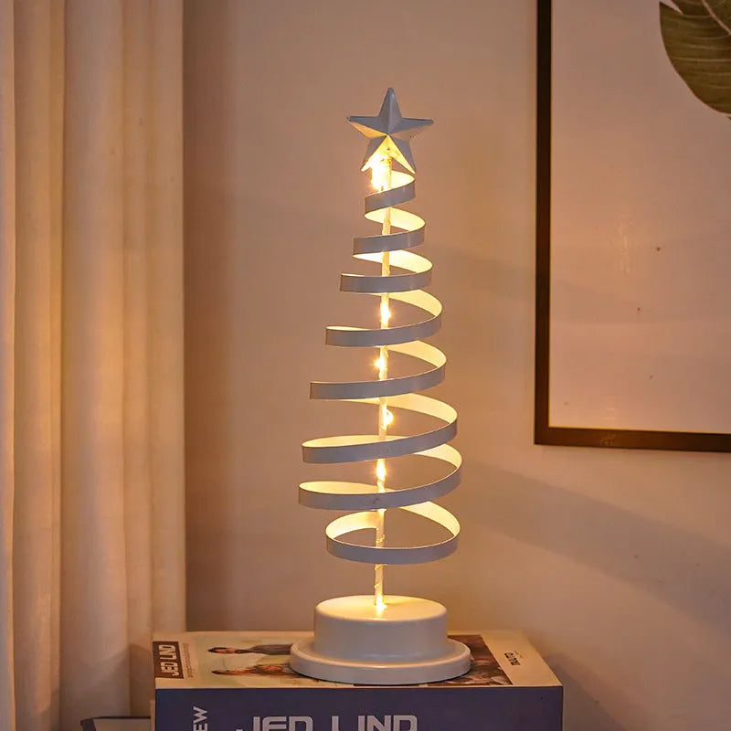 LED Christmas tree spiral light ornament with warm white glow on a table, gold finish