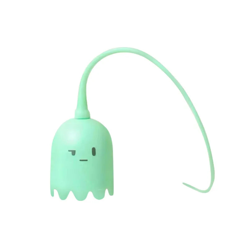 Green automatic electronic cat wand toy with a swinging silicone tail on a wooden floor.