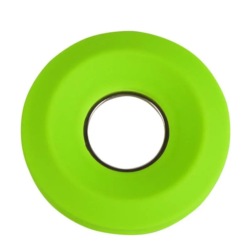 Donut silicone suction cup cord reel in green with earphone cable wound around it and magnet ring closed