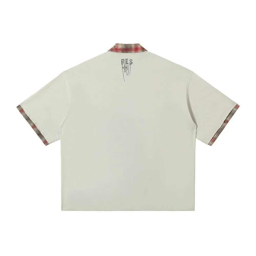 Men's loose blue short-sleeved top with asymmetric lapel and graffiti-style print.