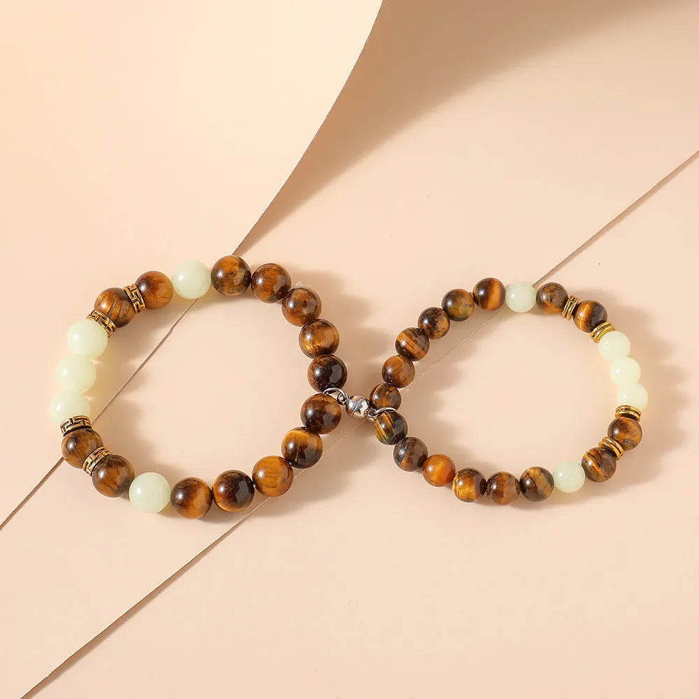 Pair of amber Y552 geometric luminous couple bracelets with patterned surface