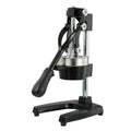 A black cast iron manual juicer with a stainless steel strainer, standing 40cm tall on a kitchen counter.