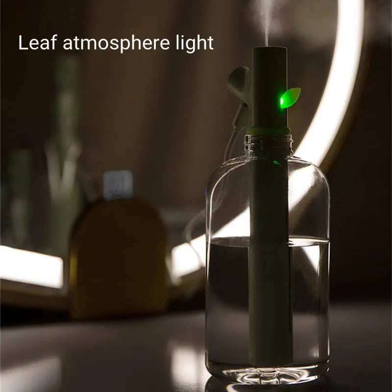 Transparent plastic mini USB branch humidifier on desk with mist output