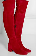 Grey women's suede over-the-knee flat boots with a pointed toe and low thick heel on a white background.