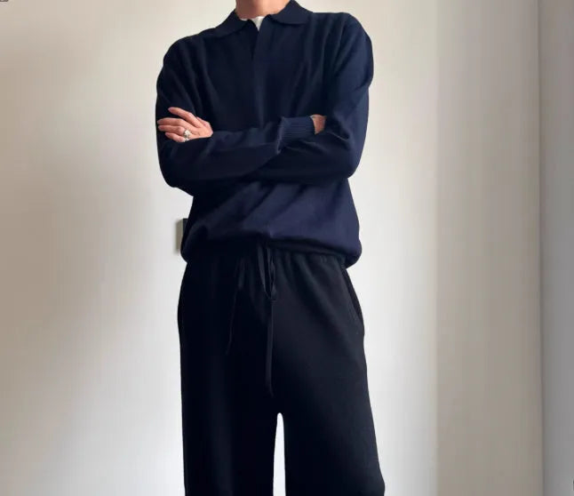 Man wearing a milky white pure wool polo sweater with a lapel collar.