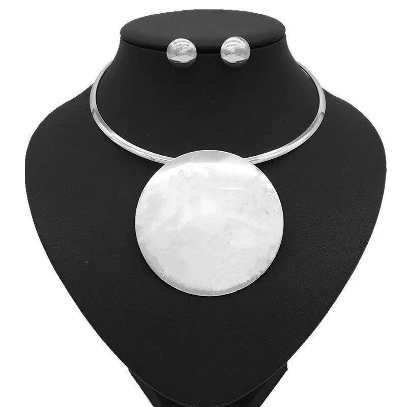 Gold alloy bead pendant necklace set on display with exaggerated design