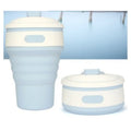 Collapsible silicone travel cup in pink folded to 6cm height with anti-hot handle and leak-proof lid
