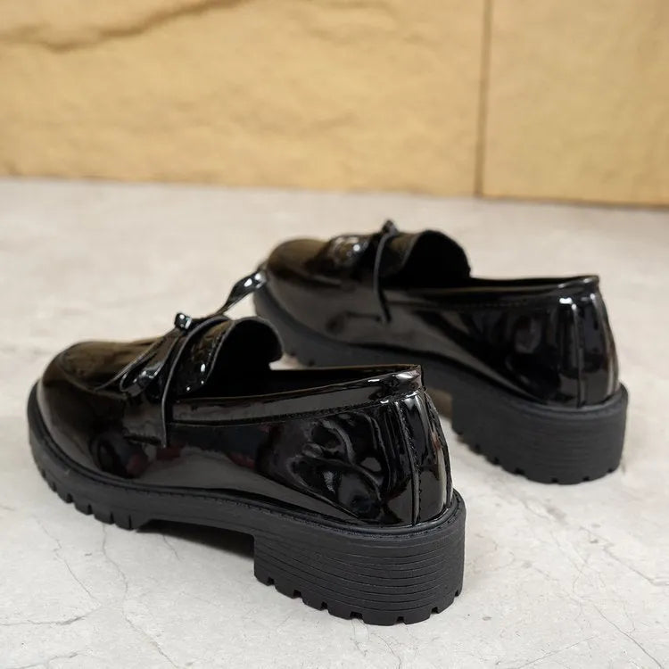Women's brown loafers with a decorative bow on the front.