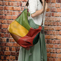 Brown cowhide leather crossbody travel bag showing front view and size scale.