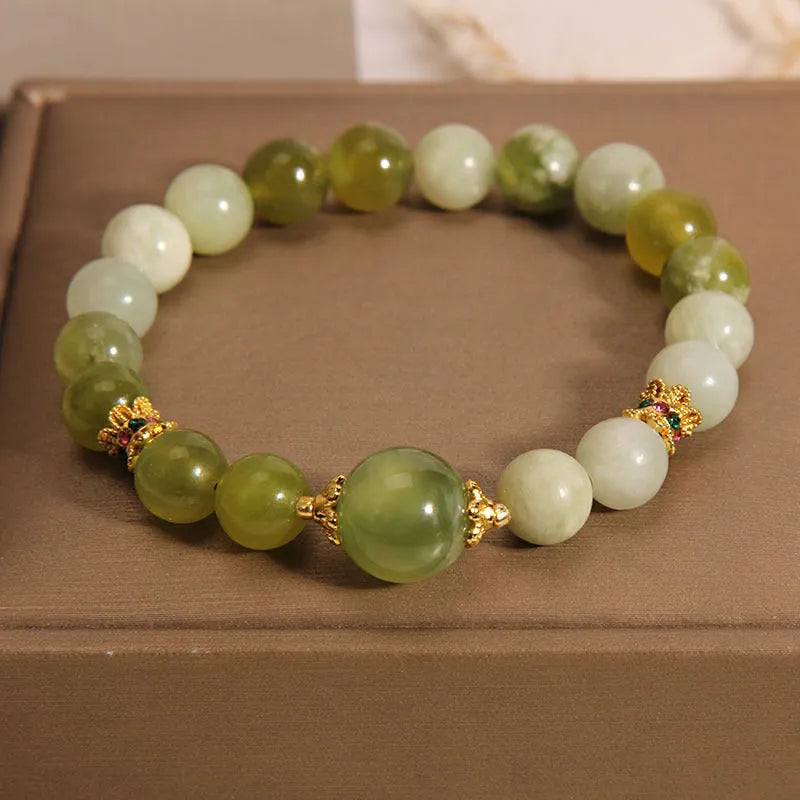 Women's bracelet in Xiuyan jade green with original design on display