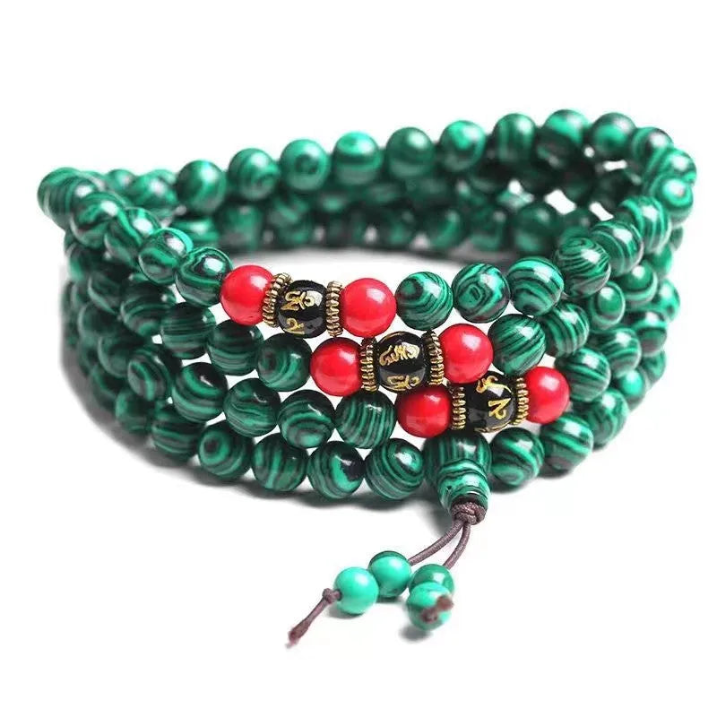 Multi-layer turquoise bracelet with 108 round polished beads in 6mm size on plain background