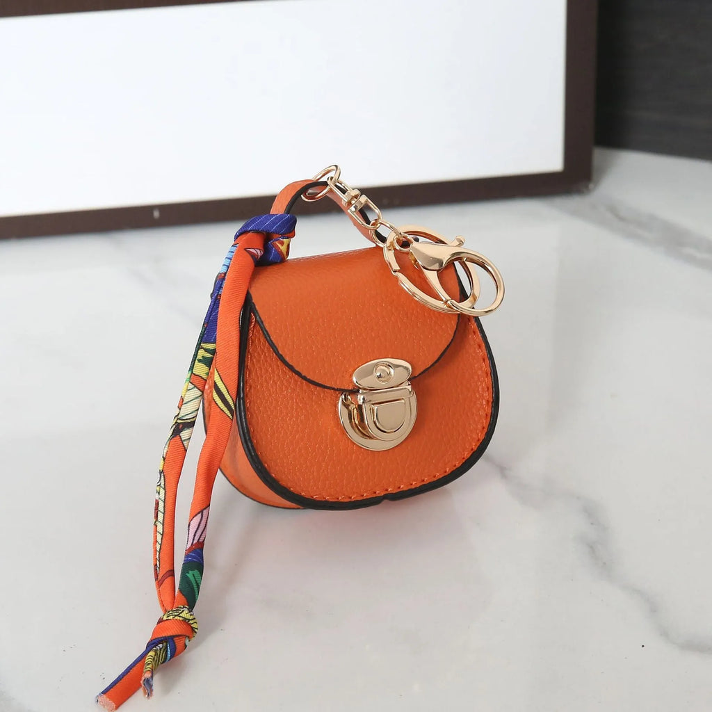 Small PVC coin purse pendant in solid colour with keychain attachment on white background