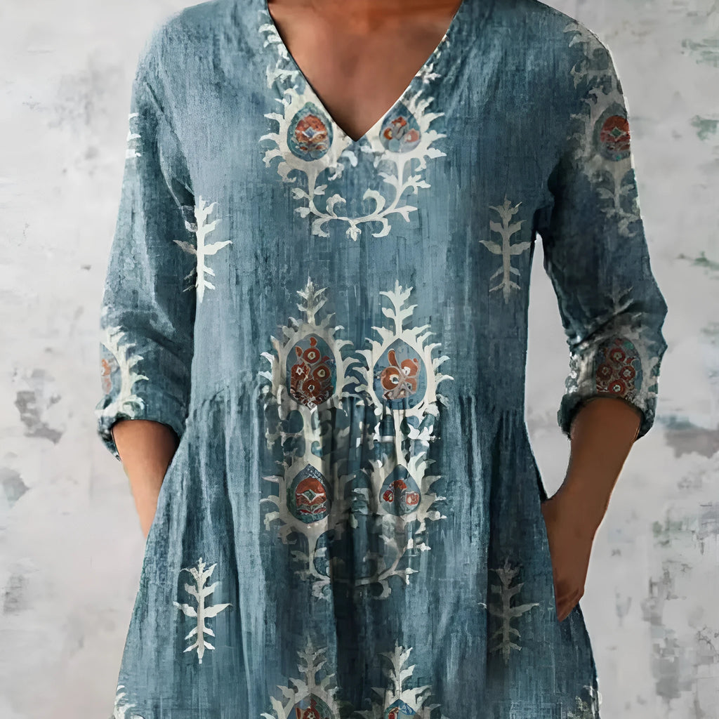 Women's printed loose dress with wide waist and 3/4 length sleeves on a hanger.