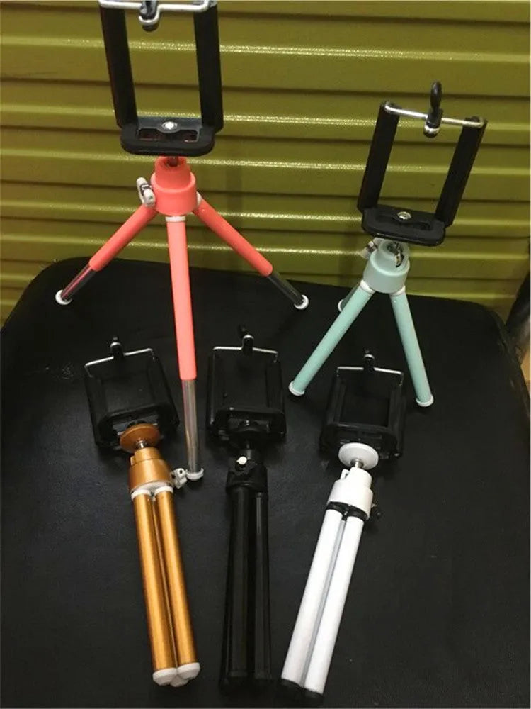 Black desktop phone holder with two-section adjustable bracket holding smartphone